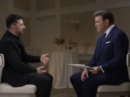 Zelenskyy gestures while explaining the 90% complete peace deal to Fox News anchor Bret Baier after Mar-a-Lago summit