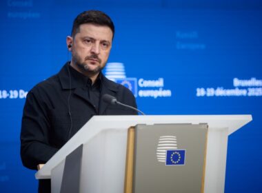 Ukrainian President Volodymyr Zelenskyy speaks at a podium during the European Council summit in Brussels, 18-19 December 2025