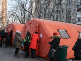 kyiv restores heating hundreds apartment blocks after russian attacks -15°c cold persists · post people wait outside mobile point where residents can warm up drink tea charge phones get help