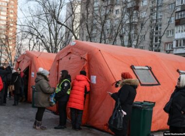 kyiv restores heating hundreds apartment blocks after russian attacks -15°c cold persists · post people wait outside mobile point where residents can warm up drink tea charge phones get help