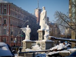 Destroyed Russian military equipment displayed in the snow near the Princess Olga Monument in Kyiv, with historic buildings in the background