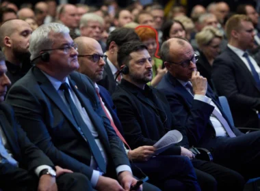 Ukrainian President Volodymyr Zelenskyy and German Chancellor Friedrich Merz at the German-Ukrainian Economic Forum in Berlin, with alleged Russian spy Ilona W. circled sitting rows behind them