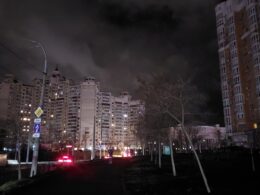 During blackouts, apartment blocks in Kyiv are mostly dark, with scattered lights from apartments with battery-powered sources. Generators power businesses on the ground floor. Street lights are largely off.