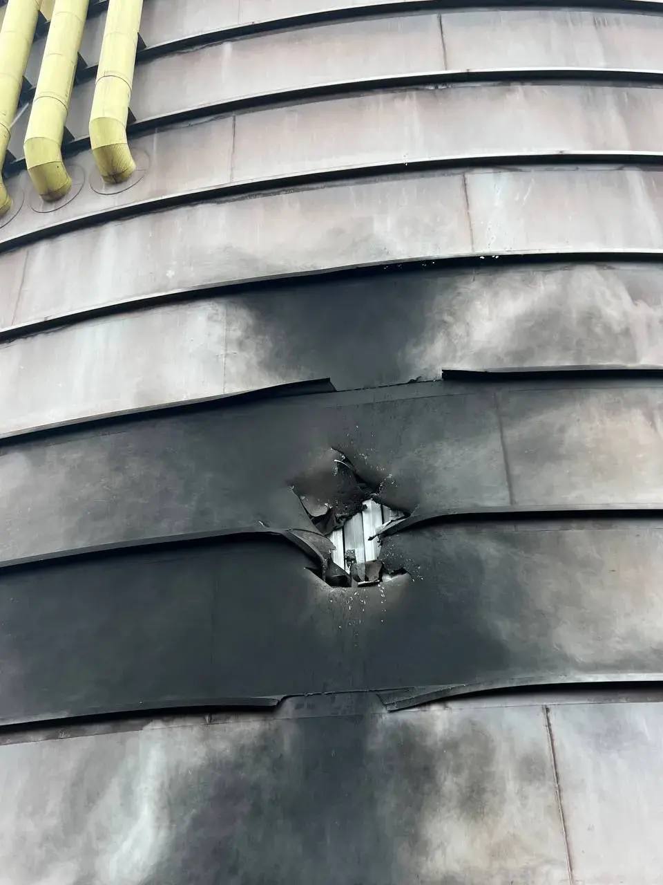 2398b4a4-bb4c-4ee7-a0d4-3b171d3f8d74 russia orders shell casings steel plant occupied alchevsk ukraine's drones struck again overnight · post hole punched through metal cladding industrial structure metallurgical luhansk oblast following ukrainian drone strike 20