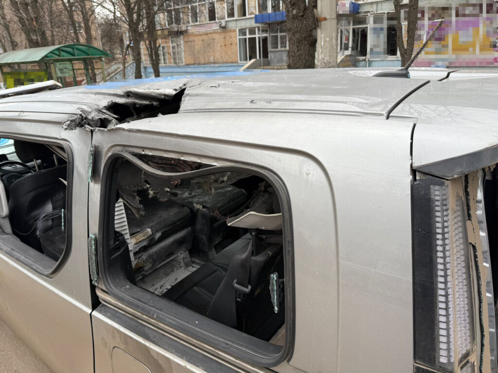 Civilian evacuation vehicle after being struck by a Russian drone in Donetsk Oblast, 20 March 2026, with humanitarian sign visible on the roof. Photo: Donetsk Regional Prosecutor’s Office