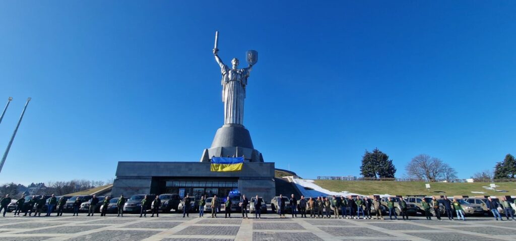 cars donated by the norwegian freedom convoy initiative lined up under kyiv’s motherland statue