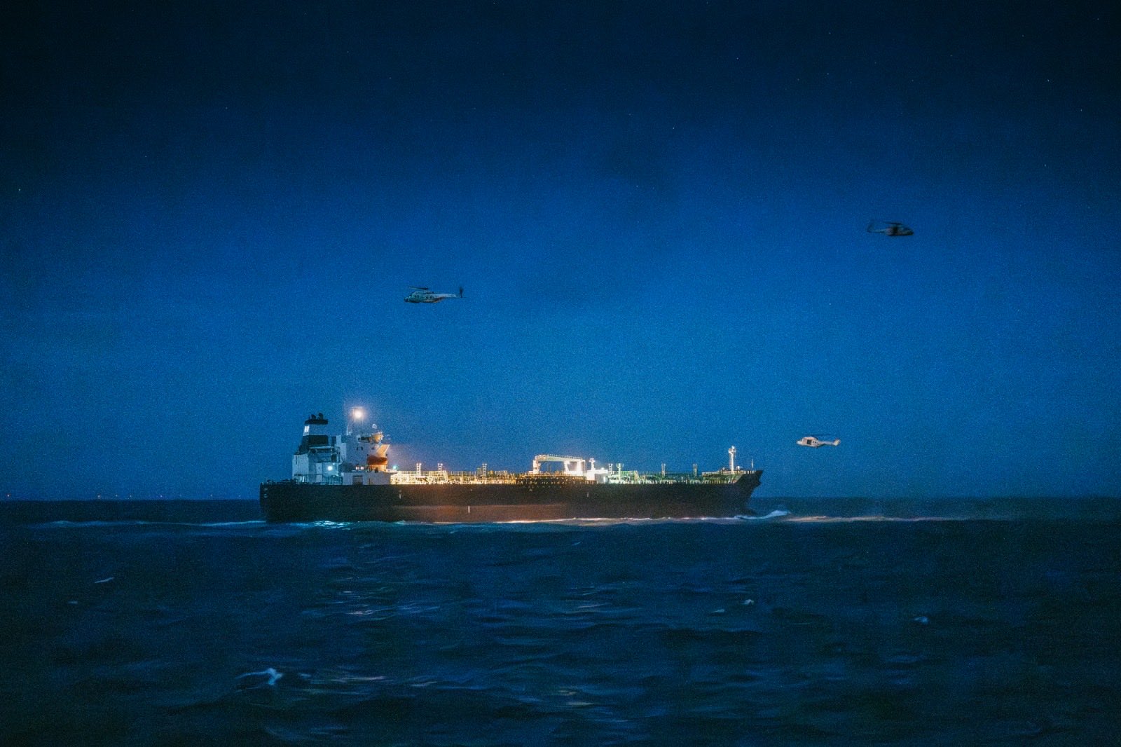 A sanctioned Russian "shadow fleet" oil tanker in the North Sea as military helicopters hover overhead during a joint Belgian-French operation to board and seize the vessel. Photo: Theo Francken