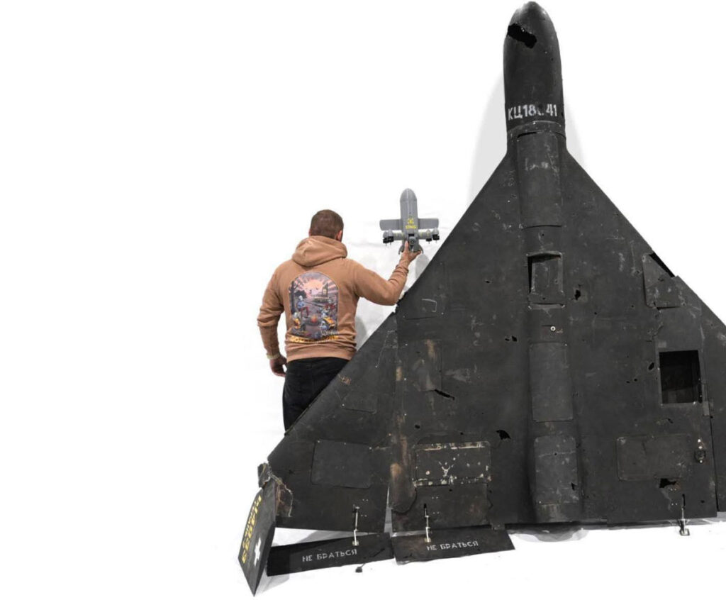 qatar want ukraine's shahed killers zelenskyy wants patriot missiles return · post man holds sting interceptor drone costing $2100 reaching up 343 km/h next downed russian shahed-136 scale sting-interceptor-drone-by-wild-hornets early-stage