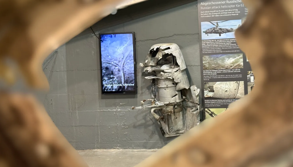 Front: parts of a stealth unmanned aerial vehicle S-70. Back: parts of a downed Russian Ka-52 helicopter. Source: berlinstory.de