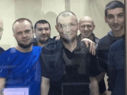 Crimean political prisoners in court in 2019: the front from left - Muslim Aliev, Vadim Siruk, Emir-Usein Kuku, Refat Alimov, at the back, from left - Envir Bekirov, Arsen Dzhepparov. All of them (except for Dzhepparov and Alimov) are still in custody as of today. Photo: Crimean Solidarity
