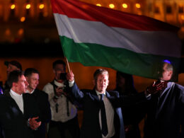 Péter Magyar waves the Hungarian flag at Tisza party's supermajority victory rally in Budapest, 12 April 2026