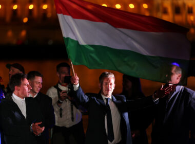 Péter Magyar waves the Hungarian flag at Tisza party's supermajority victory rally in Budapest, 12 April 2026