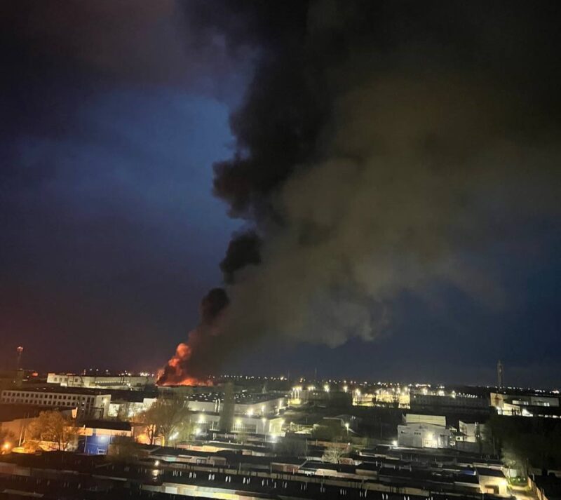 A plume of smoke rising from a burning industrial facility in Russia following a drone attack.