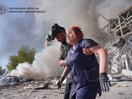 A Ukrainian rescuer holds a woman injured in a Russian aerial strike in Zaporizhzhia. Source: Zaporizhzia Regional Military Administration