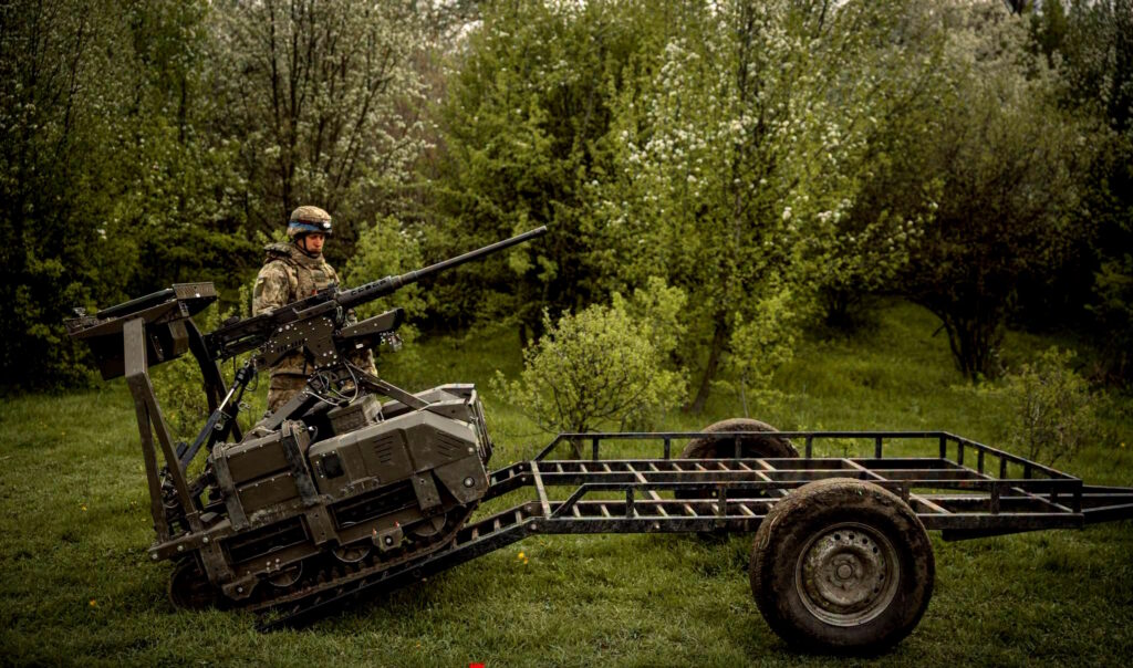 The image shows a Ukrainian soldier standing next to an unmanned ground robotic vehicle. Source: The General Staff