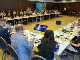 Panel discussion at the Ukraine Recovery Conference 2026 in Gdańsk, with speakers on stage and attendees in the audience