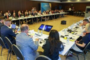 Panel discussion at the Ukraine Recovery Conference 2026 in Gdańsk, with speakers on stage and attendees in the audience