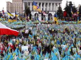 The photo shows a Memorial on the Independence Square in Kyiv, where families of fallen defenders leave thousands of flags with the names, photos, and dates of death of their relatives who gave their lives in the Russian-Ukrainian war. Source: UkrInform