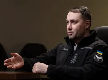 Kyrylo Budanov, head of Ukraine's Office of the President, gestures while speaking during an interview, wearing a black fleece marked with his name and the HUR insignia.