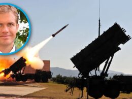 A Patriot air-defense system launches an interceptor, with an inset portrait of defense scholar Marc DeVore — illustrating Ukraine's interceptor shortage.