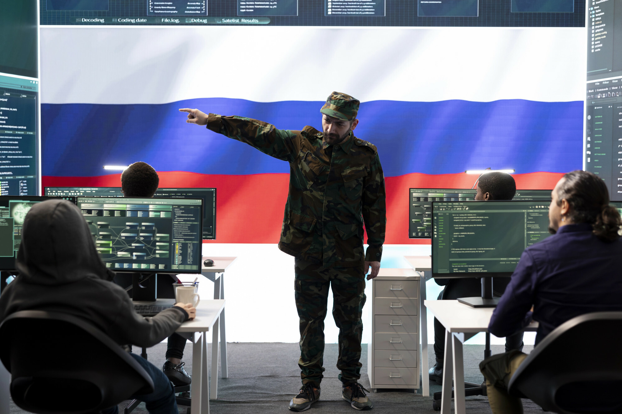 Russian army officer supervising cyber attacks on state networks, spreading misinformation and fake news around Europe during hybrid war. Military personnel works on scams and hacking. Russian disinformation misinformation cyber campaign Russian information warfare