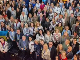 Delegates at the Global Ukrainian Summit in Bern pose for a group photograph after adopting the Bern Declaration on 7 June 2026. Many participants wear traditional Ukrainian vyshyvanky. A Ukrainian flag is visible at lower left.
