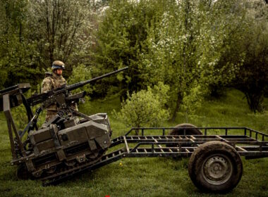 The image shows a Ukrainian soldier standing next to an unmanned ground robotic vehicle. Source: The General Staff