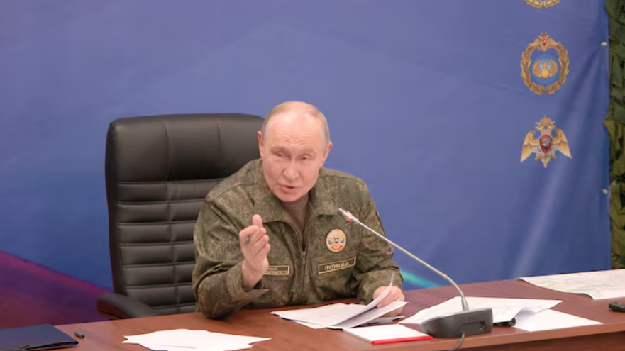 Russian President Vladimir Putin chairs a meeting at a military command post