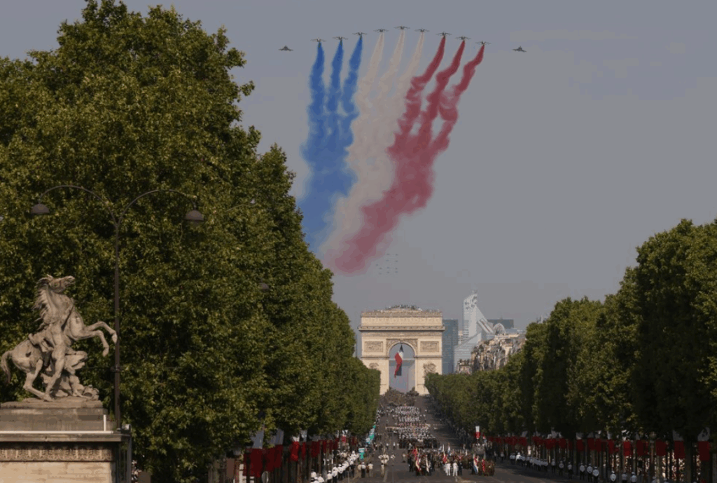 The French Air and Space Force's national aerobatic team performs a flypast during the annual Bastille Day military parade on the Champs-Élysées, with the Arc de Triomphe in the background, Paris, France, 14 July 2026. Photo: AP/Thomas Padilla