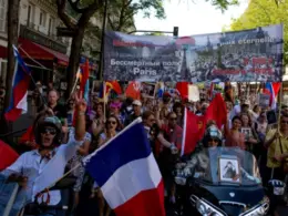 Russians demonstrating in the Immortal Regiment march in Paris, with banners unfurled, 9 May 2025