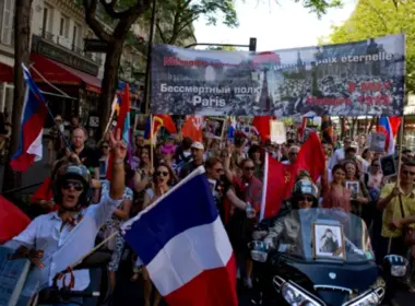 Russians demonstrating in the Immortal Regiment march in Paris, with banners unfurled, 9 May 2025