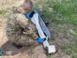 A Ukrainian Security Service officer at the crash site of a Russian drone containing uranium. Source: The SBU