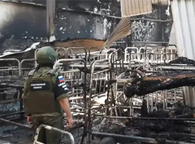olenivka officials taganrog jail land eu sanctions list abuse ukrainian prisoners · post so-called investigator russia's investigative committee stands among burned bunk beds destroyed barrack prison where russians killed war