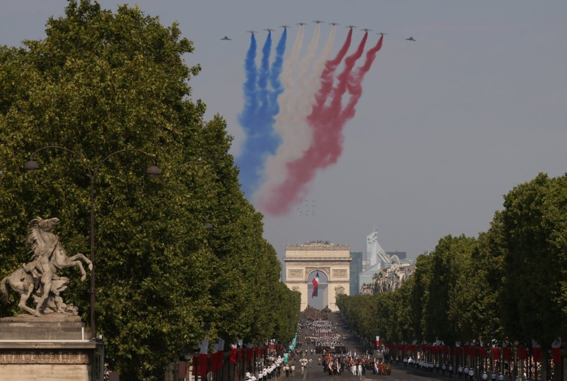 The French Air and Space Force's national aerobatic team performs a flypast during the annual Bastille Day military parade on the Champs-Élysées, with the Arc de Triomphe in the background, Paris, France, 14 July 2026. Photo: AP/Thomas Padilla