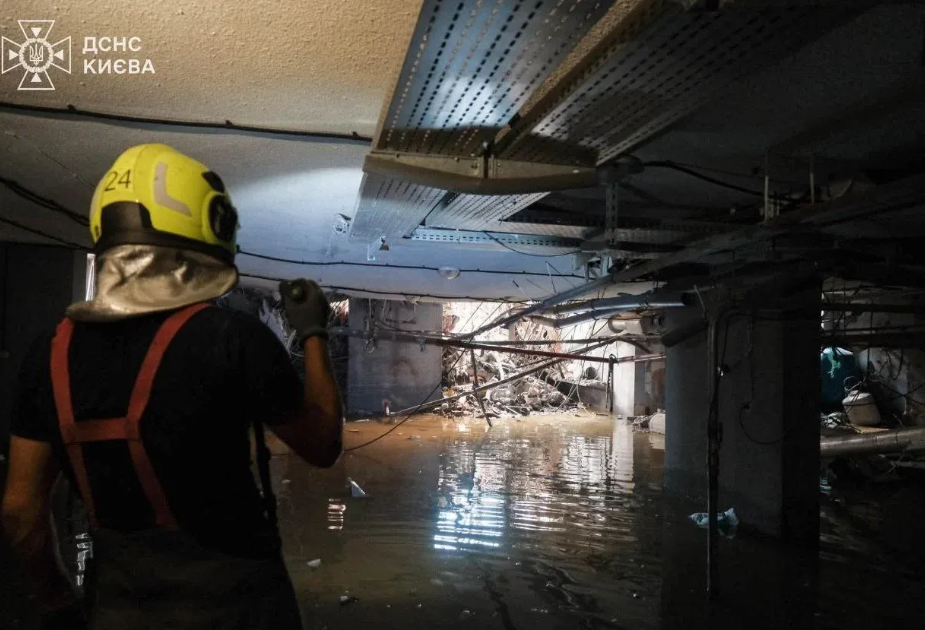 Ukrainian rescuers inside a residential building where 11 people died in a Russian attack, reportedly in a shelter located in the basement.