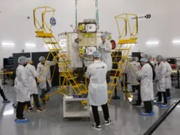 Employees of Russian company Bureau 1440 work on a Rassvet communications satellite.