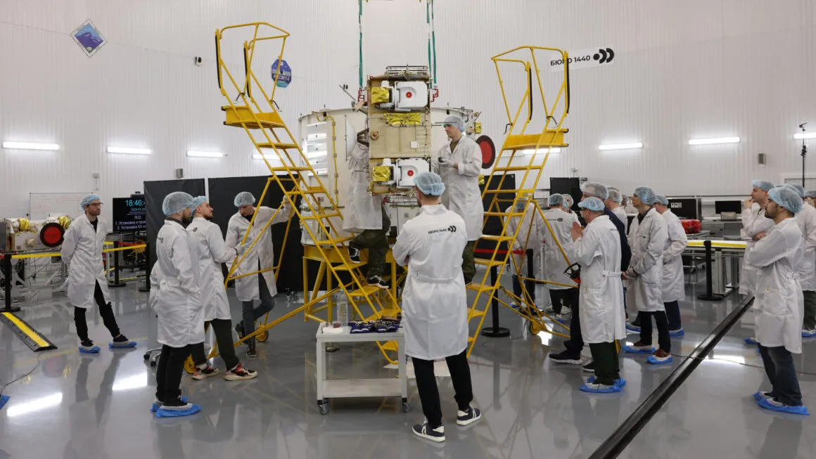 Employees of Russian company Bureau 1440 work on a Rassvet communications satellite.