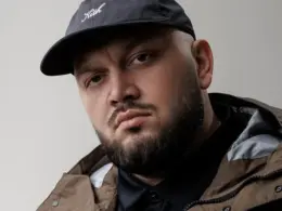 Ukrainian-American rapper Kyivstoner wearing a black cap and dark jacket.