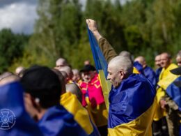 two officers 101 soldiers—ukraine's newest homecoming russian cells · post freed ukrainian defender raises fist among fellow released captives wrapped national flags 19 2026 4 pow exchange sbu5199714552638020898 ukraine news