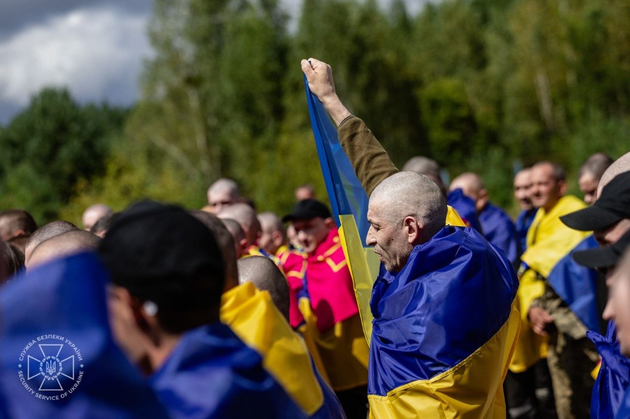 two officers 101 soldiers—ukraine's newest homecoming russian cells · post freed ukrainian defender raises fist among fellow released captives wrapped national flags 19 2026 4 pow exchange sbu5199714552638020898 ukraine news