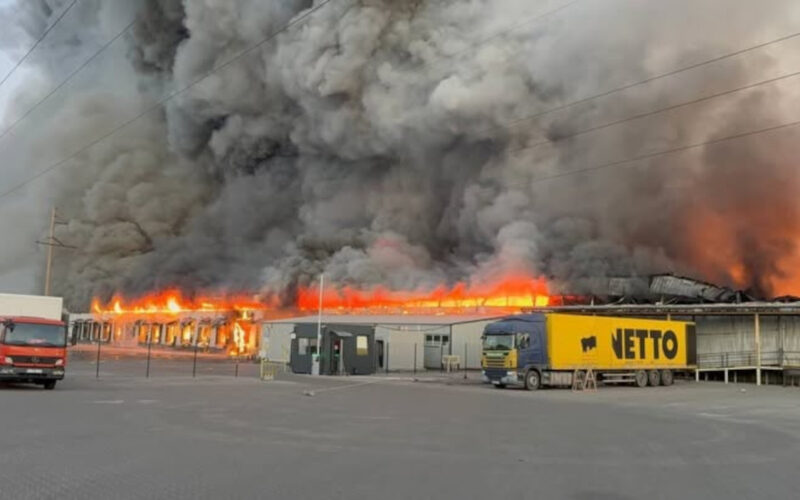 A fire burns at a Nova Poshta fulfillment and sorting center in Sviatopetrivske, Kyiv Oblast, after a Russian drone strike on 28 August 2026. More than 60,000 books were destroyed in the attack. Photo: Readeat