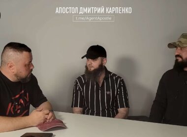 Former Akhmat fighter Magomed, center, speaks with journalist Dmytro Karpenko, left, and another man during a video interview.