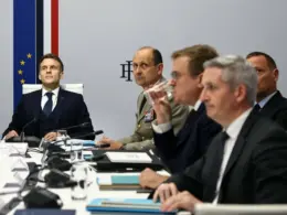French President Emmanuel Macron sits with military officers and government officials during a Coalition of the Willing meeting in Paris on 24 February 2026.