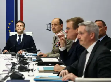 French President Emmanuel Macron sits with military officers and government officials during a Coalition of the Willing meeting in Paris on 24 February 2026.