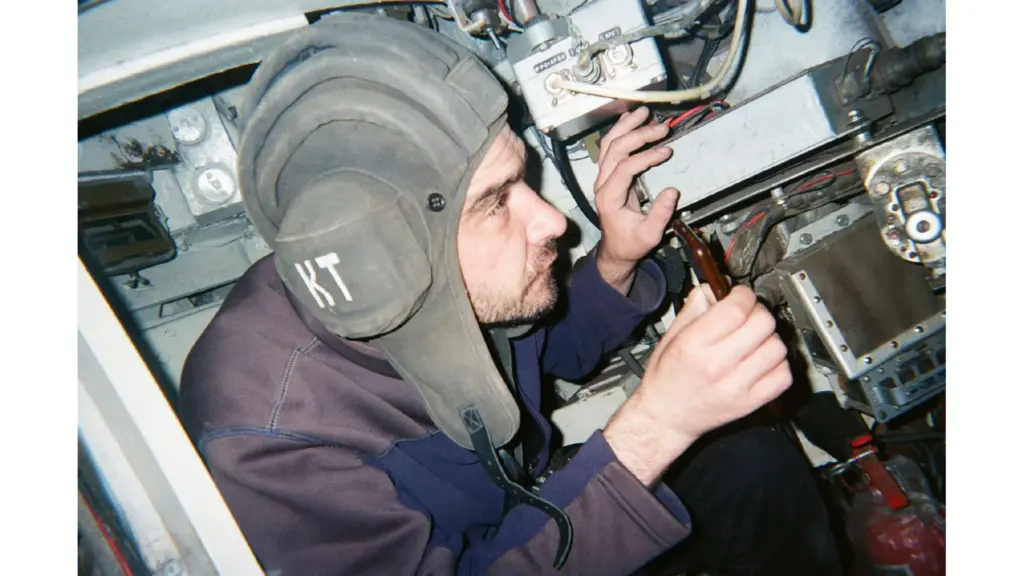 A Ukrainian serviceman works on equipment inside a military vehicle, 2025. Photo: project participant Oleksii “Lapa”