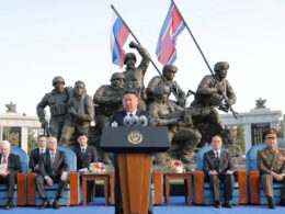 North Korean leader Kim Jong-un speaks at the opening of a memorial in Pyongyang, with Russia's Defense Minister Andrei Belousov and State Duma Speaker Vyacheslav Volodin seated behind him. April 2026. Illustrative photo: KCNA