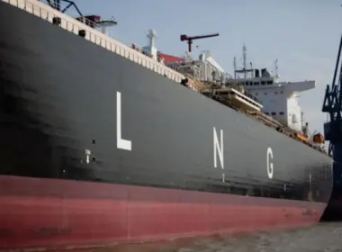 Large LNG tanker docked beside port cranes, illustrating Russian LNG imports to Belgium.