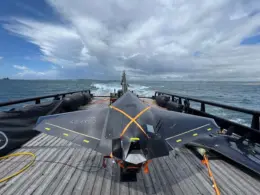 Black Nyan one-way attack drone secured to a launcher on the deck of a Royal Navy vessel at sea.