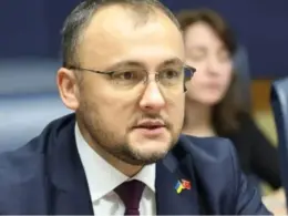 Ukraine’s Ambassador to Poland Vasyl Bodnar speaks into a microphone during a meeting.