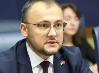 Ukraine’s Ambassador to Poland Vasyl Bodnar speaks into a microphone during a meeting.